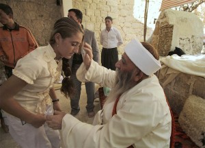 Worshipper blessed by a Yazidi Priest at Lalish Temple.